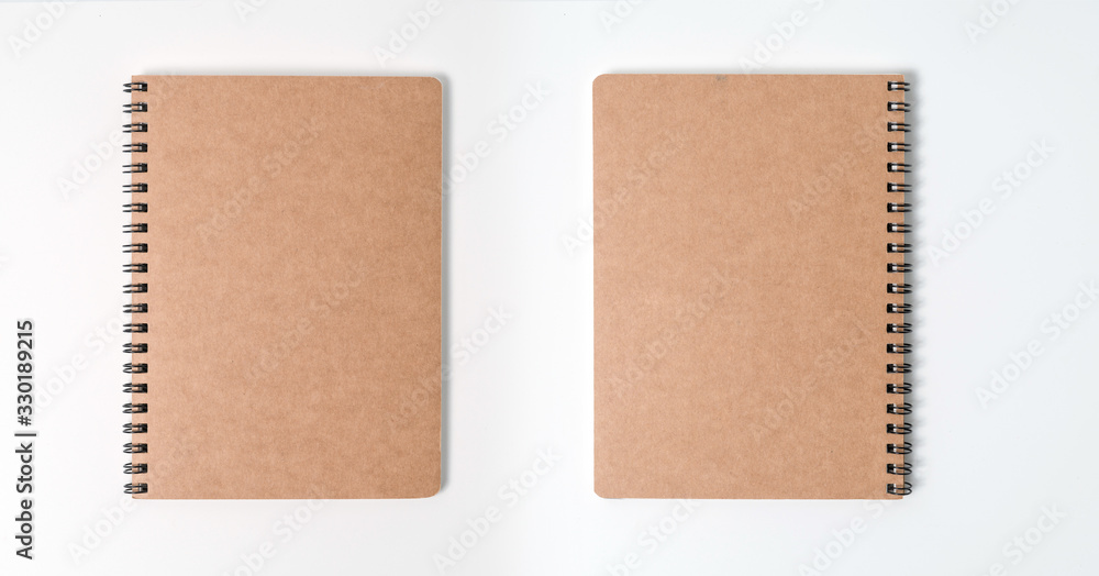 Fototapeta premium Brown spiral notebook isolated on white background.top view