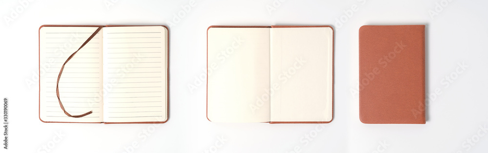 Fototapeta premium top view blank orange leather diary on white desk