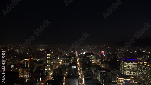 Wallpaper Mural SAPPORO, HOKKAIDO, JAPAN - FEB 2020 : Aerial high angle sunrise view of cityscape of Sapporo city. View of buildings and street traffic around Susukino downtown area. Time lapse shot night to morning. Torontodigital.ca