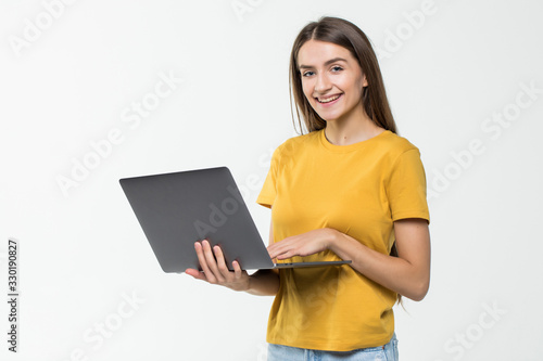 Portrait of a happy woman working on laptop computer isolated over white background