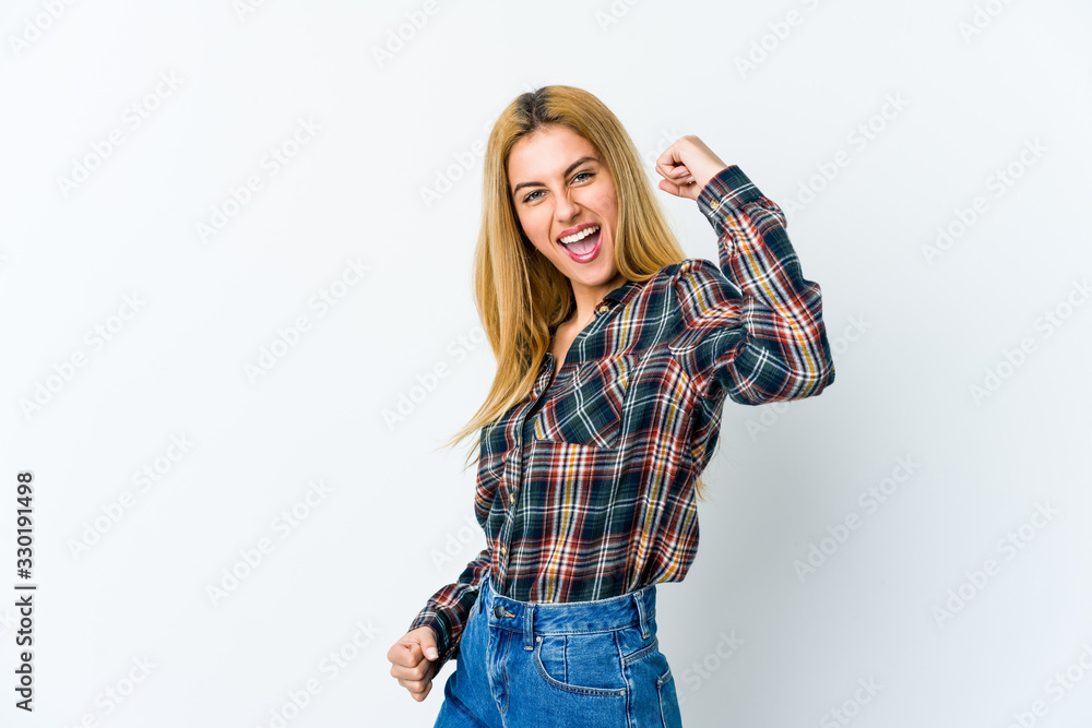 Young blonde woman isolated on white background cheering carefree and excited. Victory concept. Young blonde woman isolated on white background cheering carefree and excited. Victory concept.