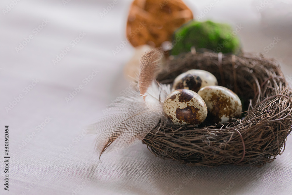 Easter festive spring table setting decoration, eggs in nest, selective focus, toned, top view Easter festive spring table setting decoration, eggs in nest, selective focus, toned, top view