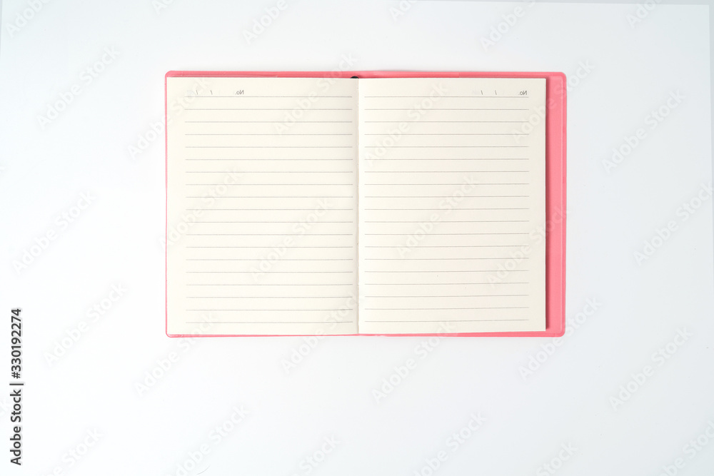 Pink notebook on white desk. Business minimal concept for women. Flat lay, top view, copy space Pink notebook on white desk. Business minimal concept for women. Flat lay, top view, copy space