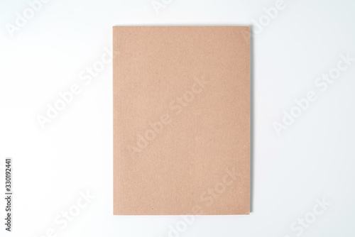 Brown spiral notebook isolated on white background.top view © yaophotograph