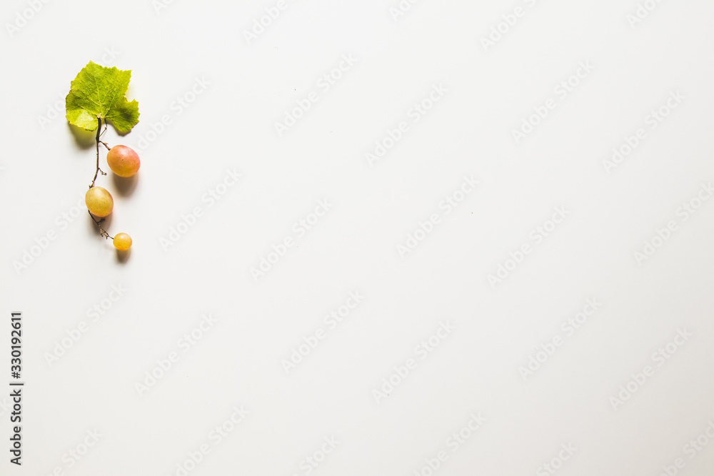 Ripe red grape with leaves isolated on white Ripe red grape with leaves isolated on white