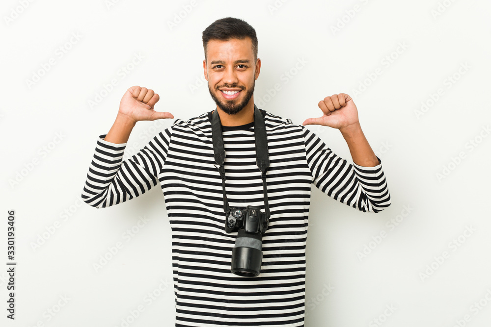 Naklejka premium Young south-asian photographer feels proud and self confident, example to follow.