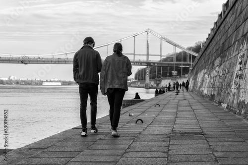 Girl and boy walks along the embankment