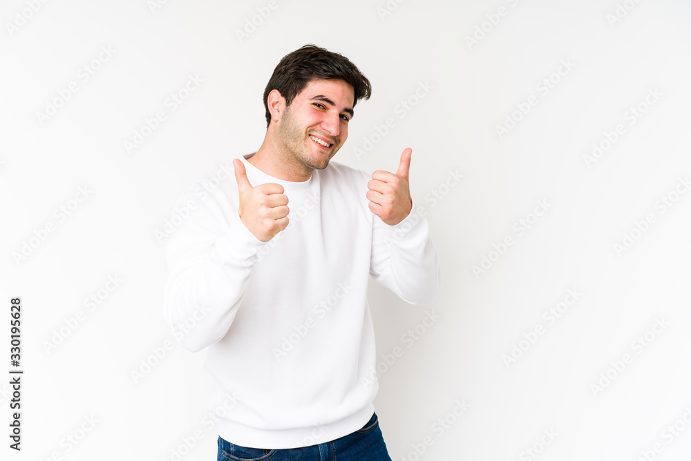 Young man isolated on white background raising both thumbs up, smiling and confident. Young man isolated on white background raising both thumbs up, smiling and confident.