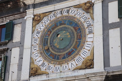 the clock tower with historical astronomical clock in Brescia, Italy photo