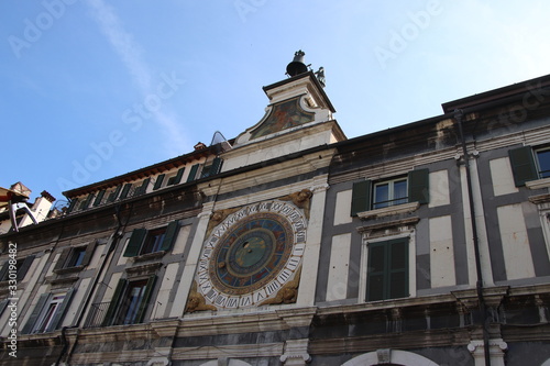 the clock tower with historical astronomical clock in Brescia, Italy photo