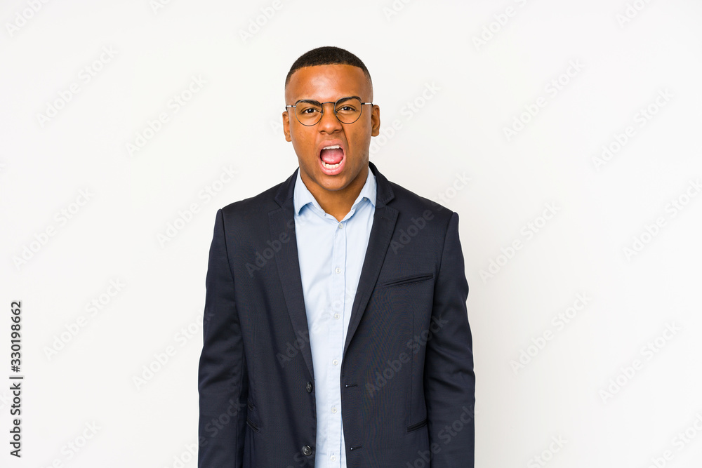 Young business latin man isolated on white background screaming very angry and aggressive. Young business latin man isolated on white background screaming very angry and aggressive.