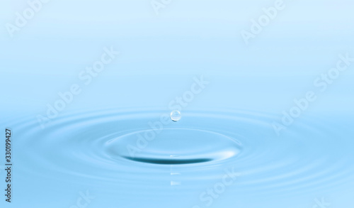 Water drop and circle ripple, light blue water, close up