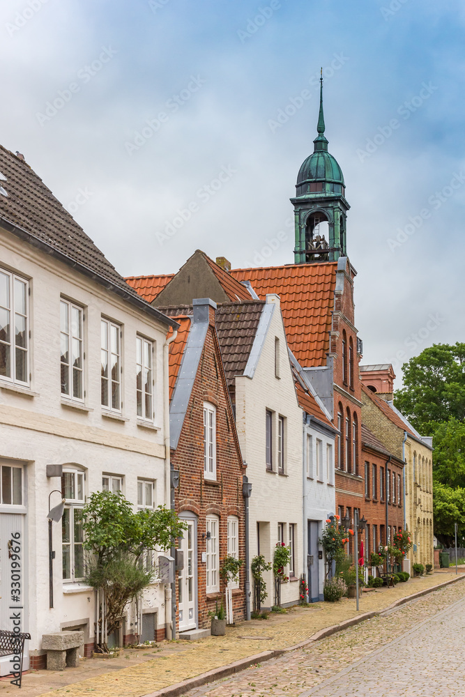 Street with old houses and church in Friedrichstadt, Germany