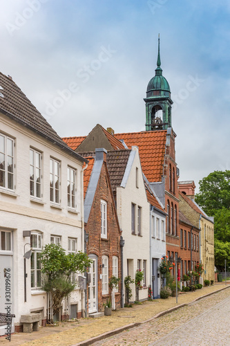 Street with old houses and church in Friedrichstadt, Germany