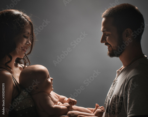 Young family and newborn baby studio shot photo