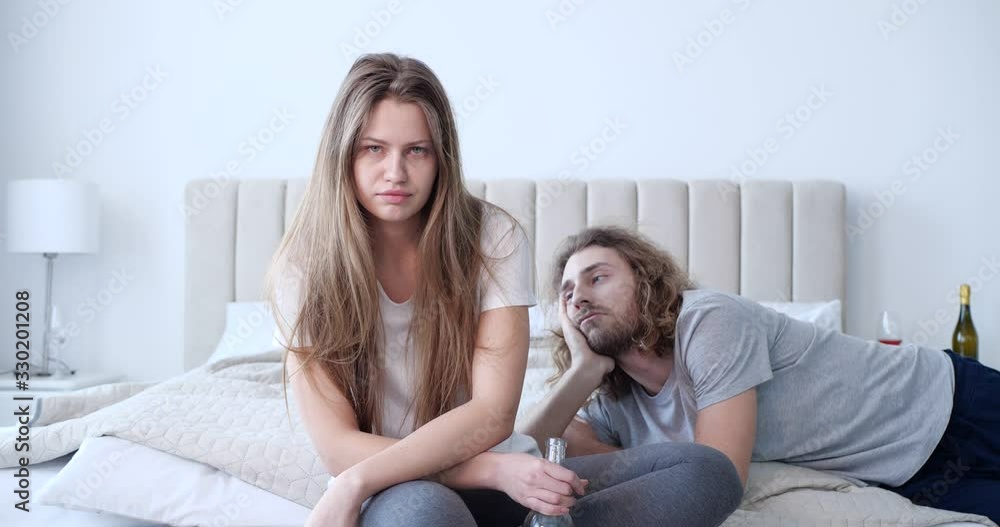 Drunk couple in bedroom at home. Alcohol addiction Drunk couple in bedroom at home. Alcohol addiction