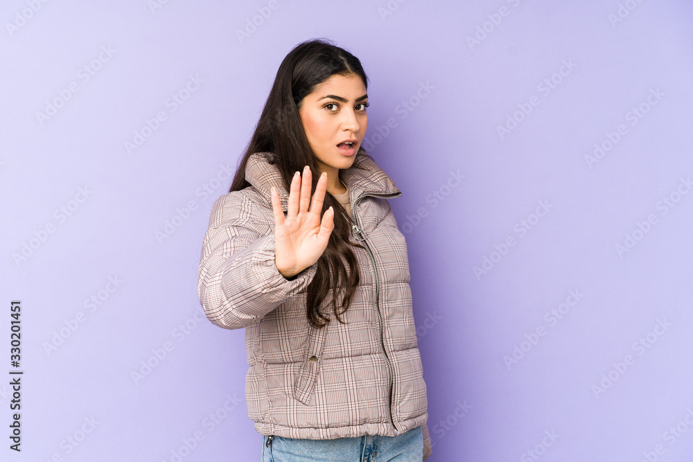 Young indian woman isolated on purple background being shocked due to an imminent danger Young indian woman isolated on purple background being shocked due to an imminent danger