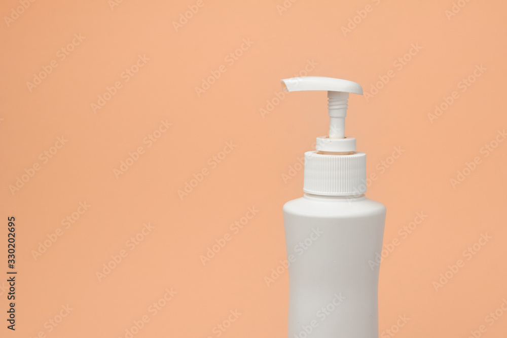 Mock up of white bottle with with a dispenser on a orange background. Cosmetics packaging. Copy space for advertisement for cosmetic product. Mock up of white bottle with with a dispenser on a orange background. Cosmetics packaging. Copy space for advertisement for cosmetic product.