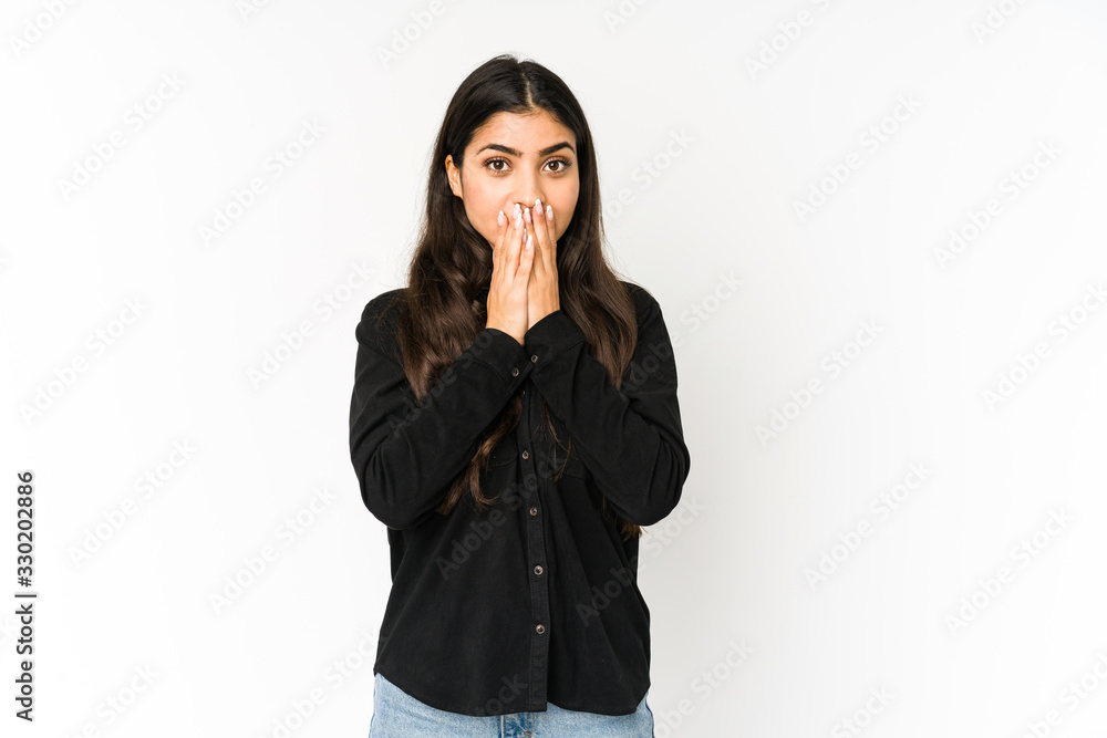 Young indian woman isolated on purple background shocked covering mouth with hands. Young indian woman isolated on purple background shocked covering mouth with hands.