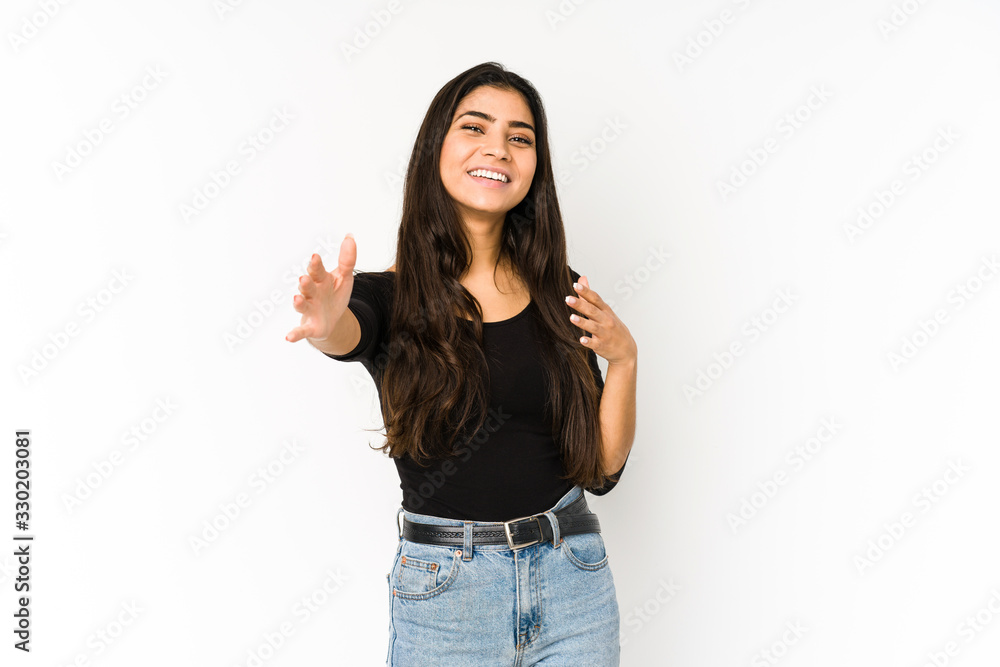 Young indian woman isolated on purple background feels confident giving a hug to the camera. Young indian woman isolated on purple background feels confident giving a hug to the camera.