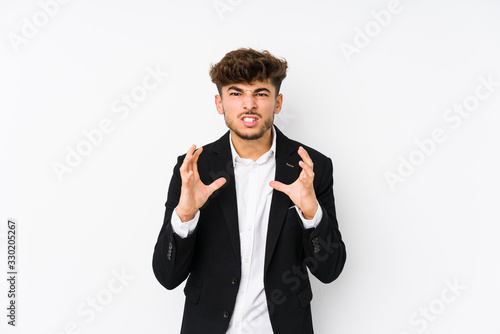 Young arabian business man isolated upset screaming with tense hands.