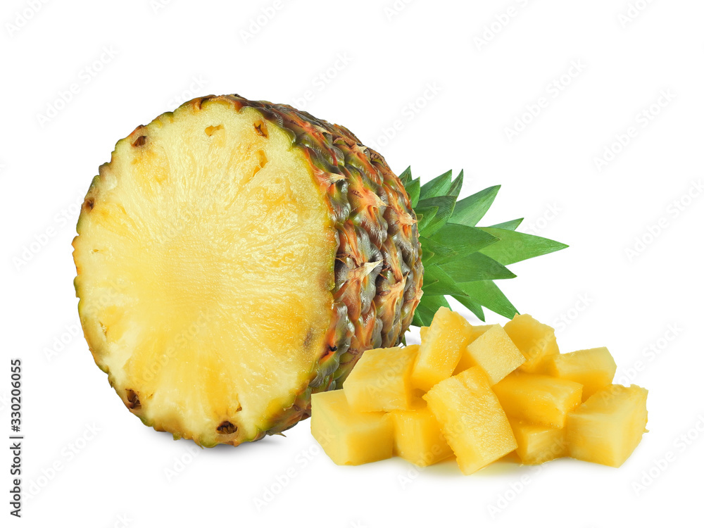 Ripe halved pineapple next to heap of juicy chunks isolated on white background Ripe halved pineapple next to heap of juicy chunks isolated on white background