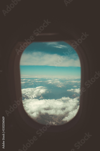 Looking through window aircraft during flight in wing with a nice blue sky