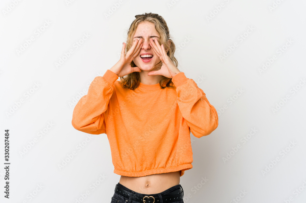 Young caucasian woman on white backrgound shouting excited to front. Young caucasian woman on white backrgound shouting excited to front.