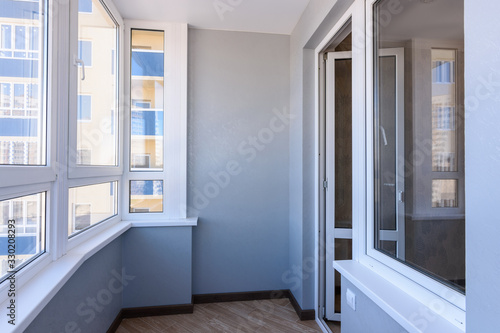 Glazed balcony in the new building, view of the entrance to the balcony