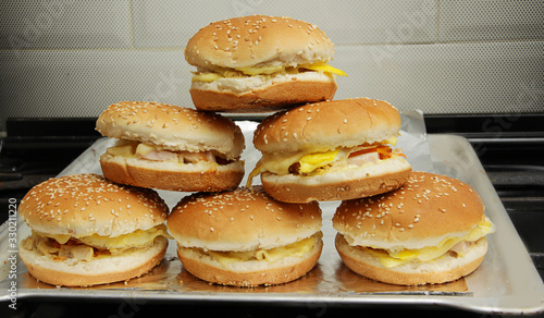 mountain of ready-made cheeseburgers and burgers
