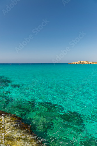 CYPRUS, NISSI BEACH - MAY 12/2018: Tourists relax and swim on one of the most popular beaches on the island.