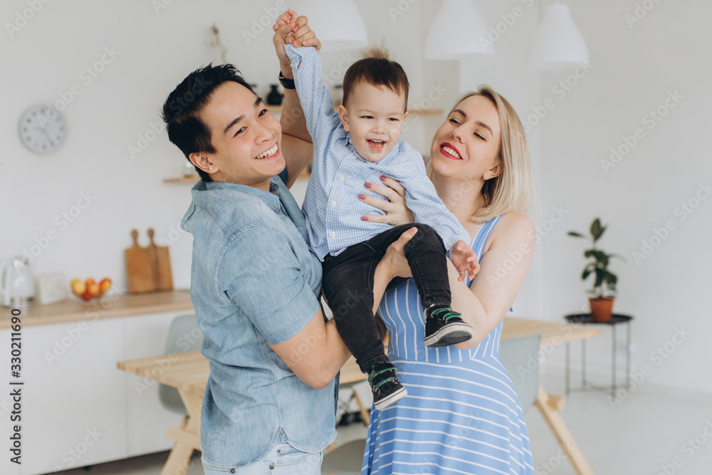 Happy multicultural family having fun together in the kitchen Happy multicultural family having fun together in the kitchen