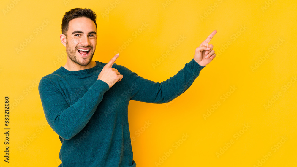 Young caucasian man isolated on yellow bakground dancing and having fun. Young caucasian man isolated on yellow bakground dancing and having fun.