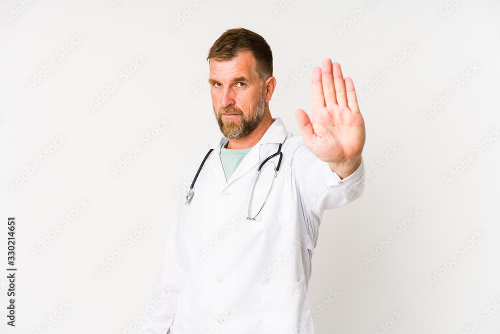 Senior doctor man isolated on white background standing with outstretched hand showing stop sign, preventing you. Senior doctor man isolated on white background standing with outstretched hand showing stop sign, preventing you.