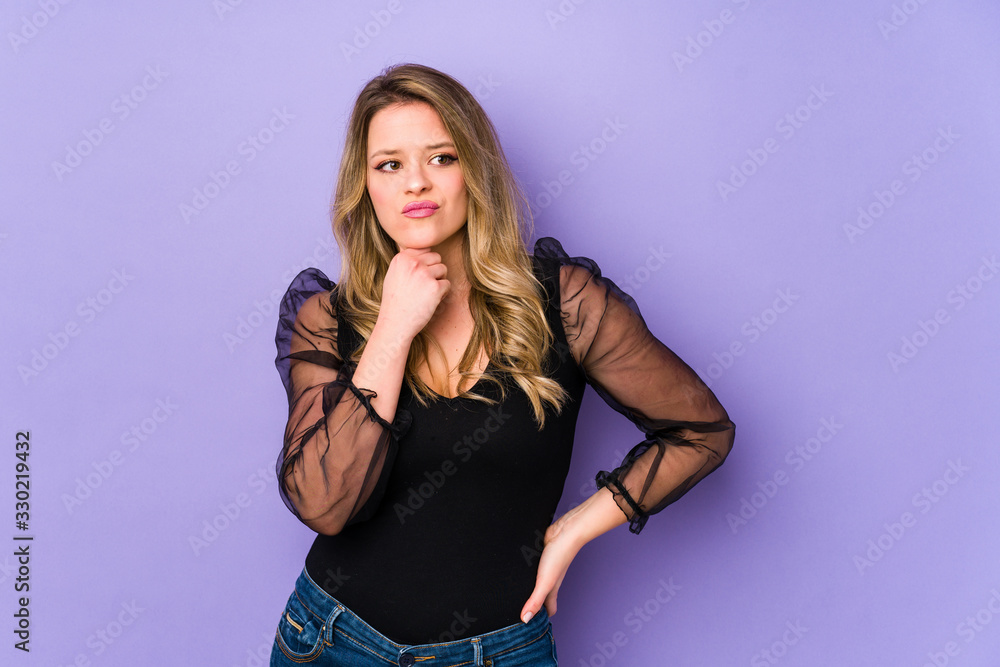 Young caucasian woman isolated on purple background suffers pain in throat due a virus or infection. Young caucasian woman isolated on purple background suffers pain in throat due a virus or infection.