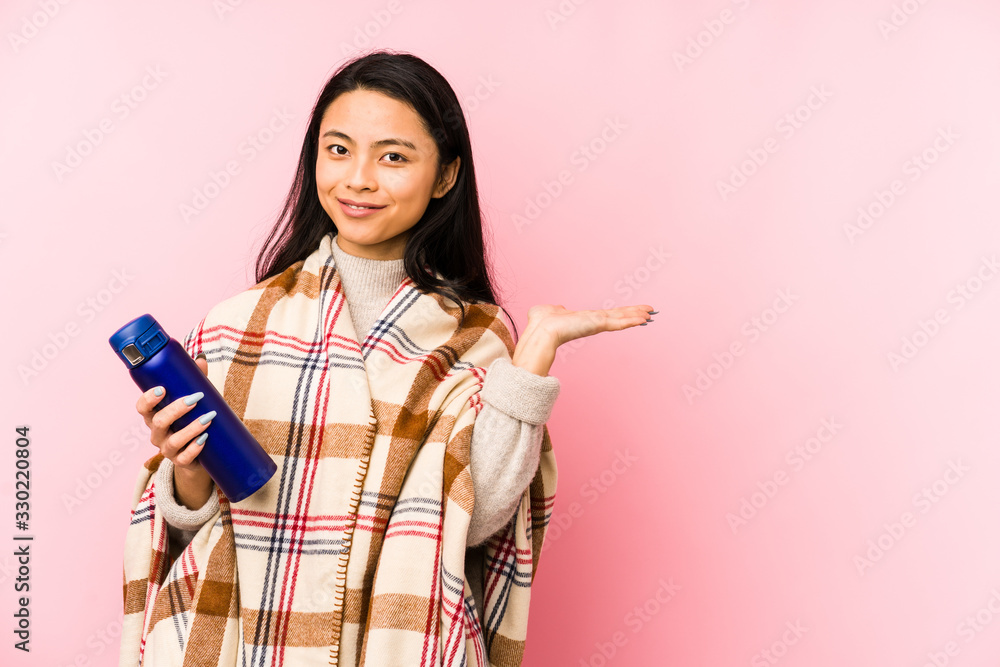 Young chinese woman doing a camping isolated on pink background relaxed thinking about something looking at a copy space. Young chinese woman doing a camping isolated on pink background relaxed thinking about something looking at a copy space.