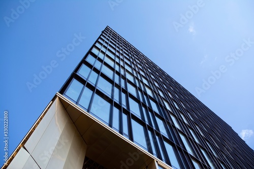 Modern office building facade abstract fragment  shiny windows in steel structure