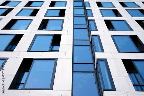 Modern office building facade abstract fragment, shiny windows in steel structure