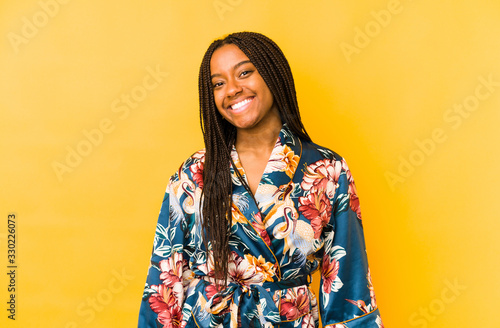 Young african american woman wearing an asiatic pijama isolated happy, smiling and cheerful.