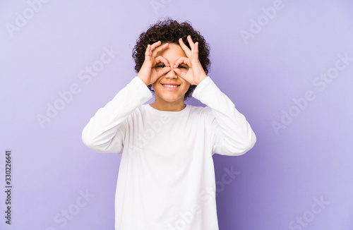 African american little boy isolated showing okay sign over eyes