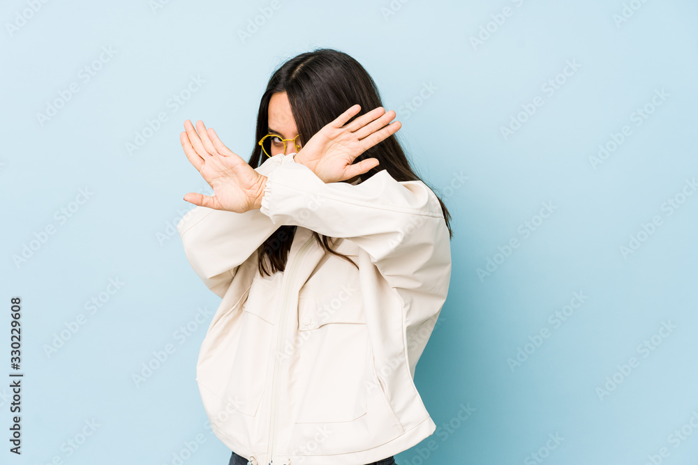 Young mixed race hispanic woman isolated keeping two arms crossed, denial concept. Young mixed race hispanic woman isolated keeping two arms crossed, denial concept.