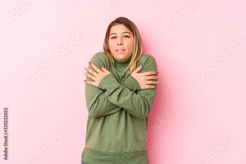 Young caucasian woman posing isolated  going cold due to low temperature or a sickness. © Asier