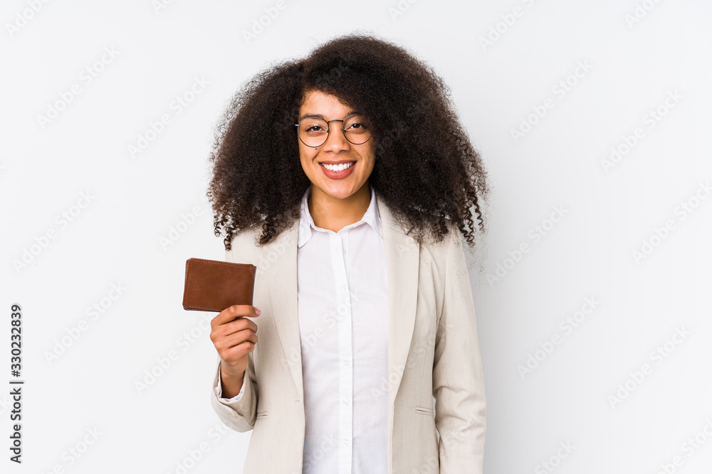 Obraz premium Young afro business woman holding a credit car isolated Young afro business woman holding a credit carhappy, smiling and cheerful.