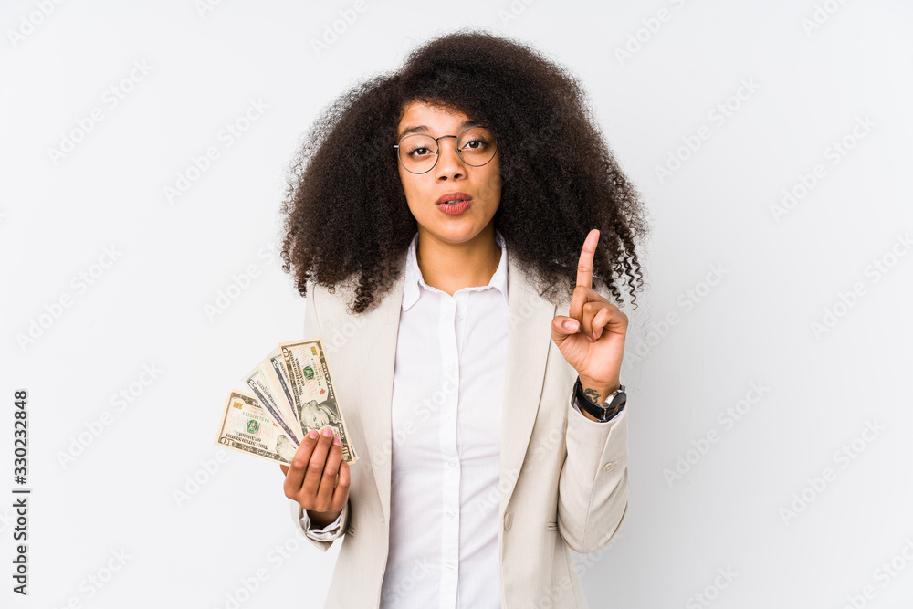 Young afro business woman holding a credit car isolated Young afro business woman holding a credit carhaving some great idea, concept of creativity. Young afro business woman holding a credit car isolated Young afro business woman holding a credit carhaving some great idea, concept of creativity.