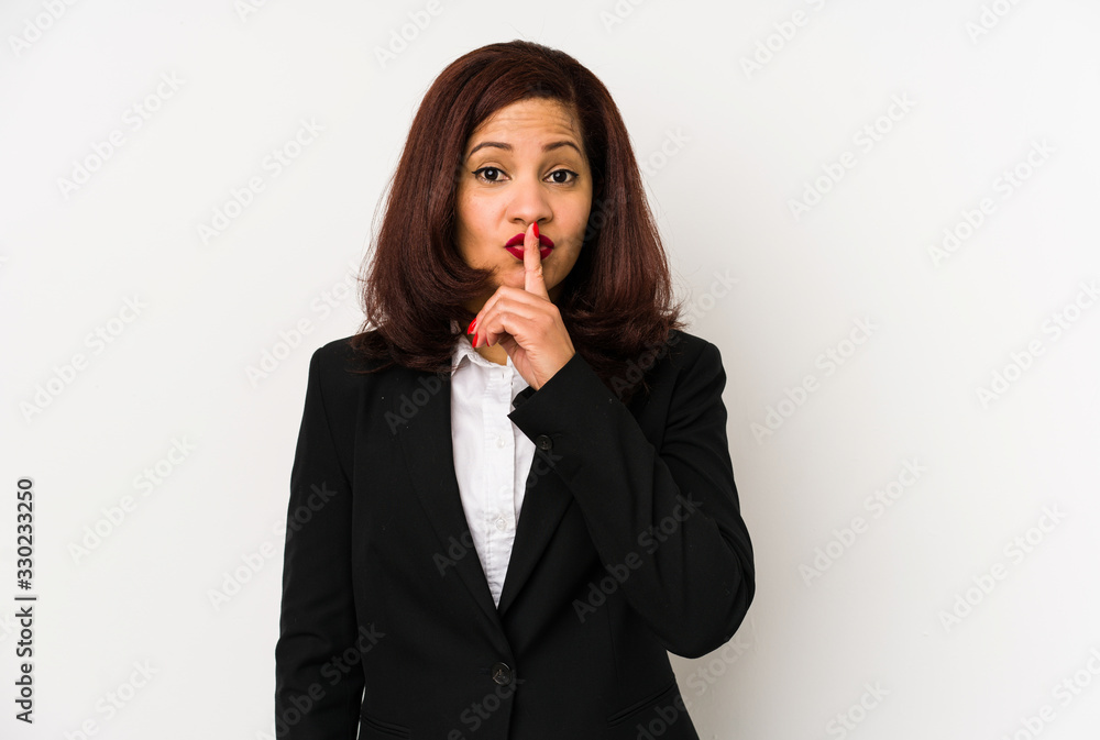 Middle age latin business woman isolated keeping a secret or asking for silence. Middle age latin business woman isolated keeping a secret or asking for silence.