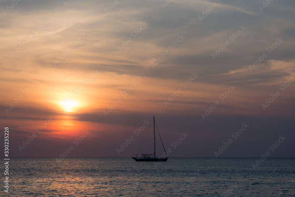 Moody scene of ship on horizon during sunset in Thailand Moody scene of ship on horizon during sunset in Thailand
