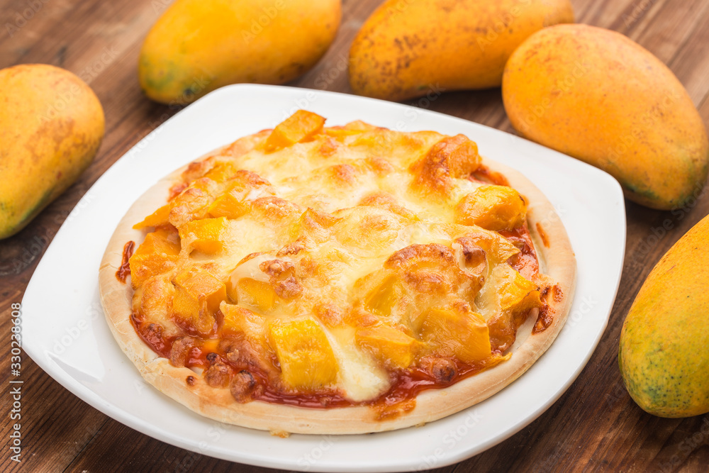 Fresh mango pizza on the table Fresh mango pizza on the table