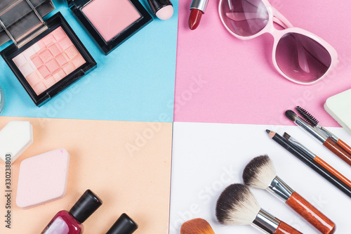 Cosmetic bag and makeup products on color background