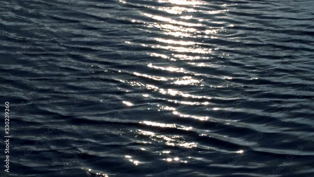 Beautiful top view of the waves in the ocean. Bright reflection of the sun on the surface of the water. A unique game of light, glare of light in reflection and refraction waves. looped Beautiful top view of the waves in the ocean. Bright reflection of the sun on the surface of the water. A unique game of light, glare of light in reflection and refraction waves. looped