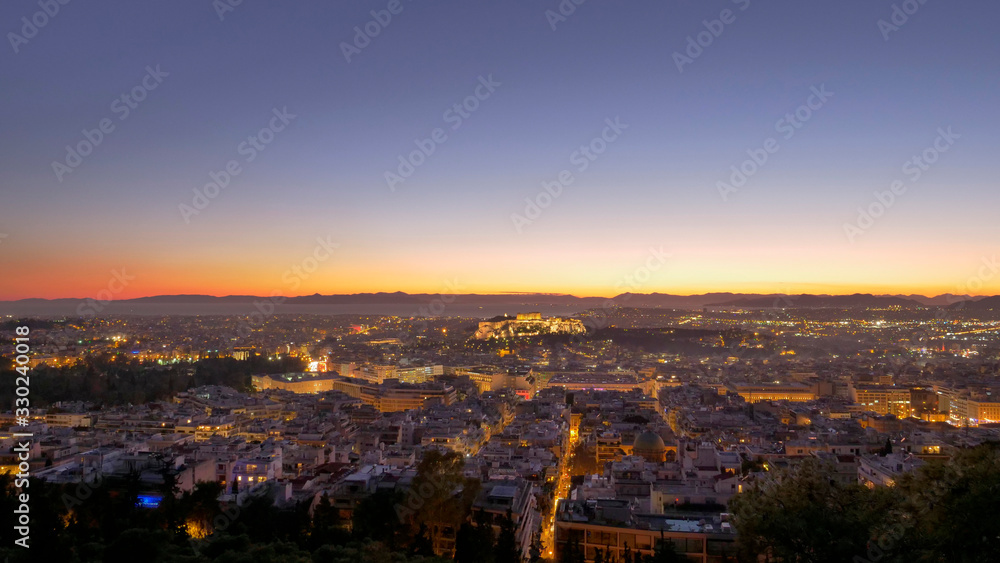 Aerial panorama view of night city skyline with orange sky 